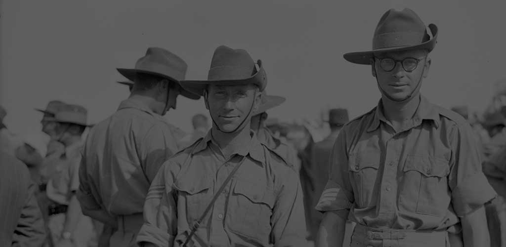 Old war related photograph shows a couple of ANZAC soldiers posing for the camera while in formation, matte applied