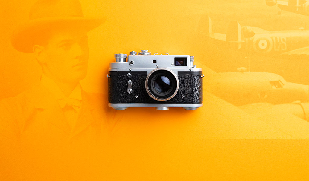 Photo restoration services on a yellow background and a vintage camera