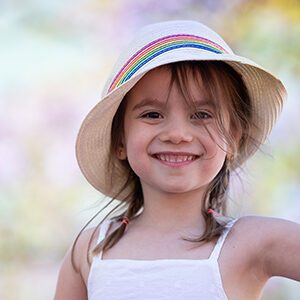 young girl headshot wearing a hat