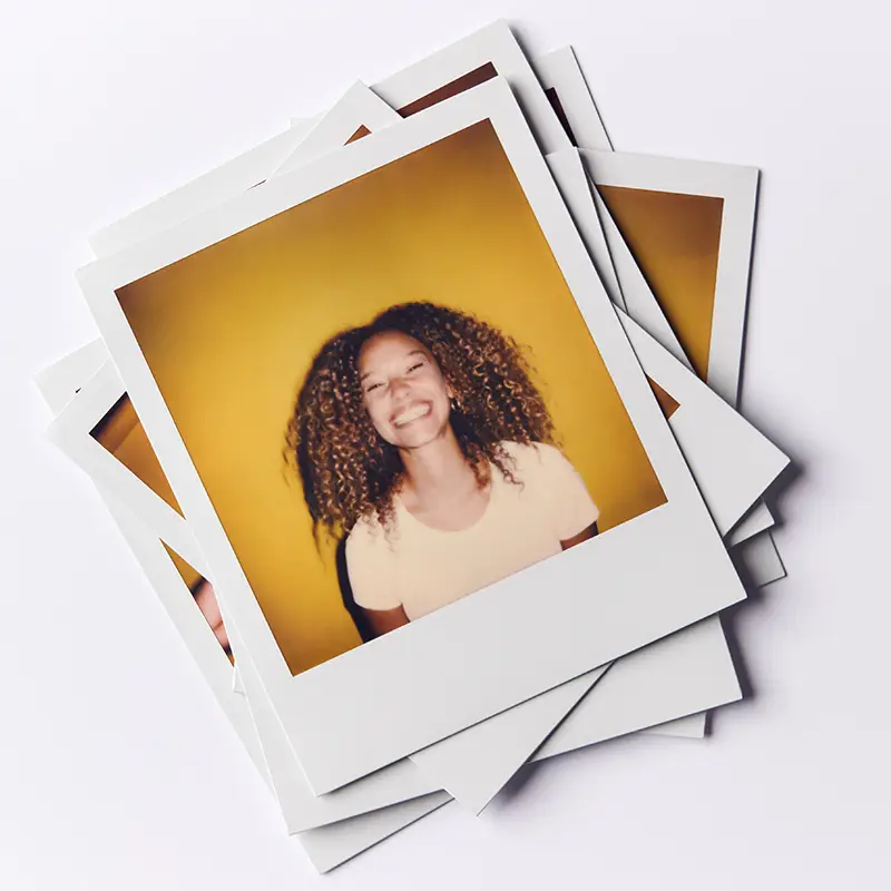 Printed photographs, a set of instant photographs stacked with a beautiful girl with curly hair at the front