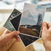 hand-hoding-a-set-of-photos Hand holding a set of photographs
