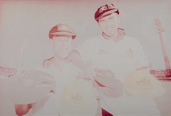 faded photo of cricket players prior restoration